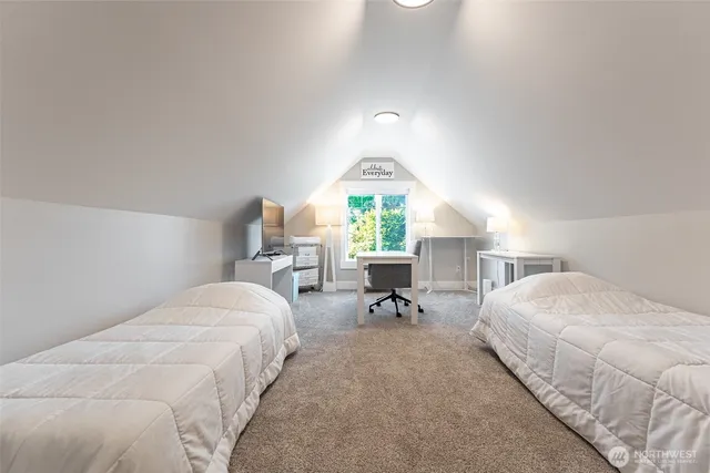 a bedroom with bed and a chandelier