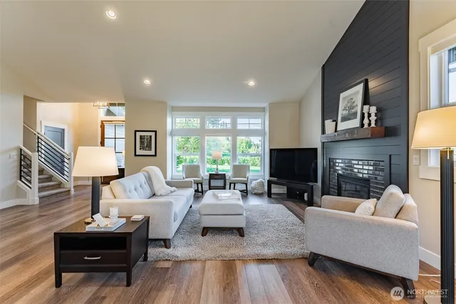 a living room with furniture a large window and a fireplace