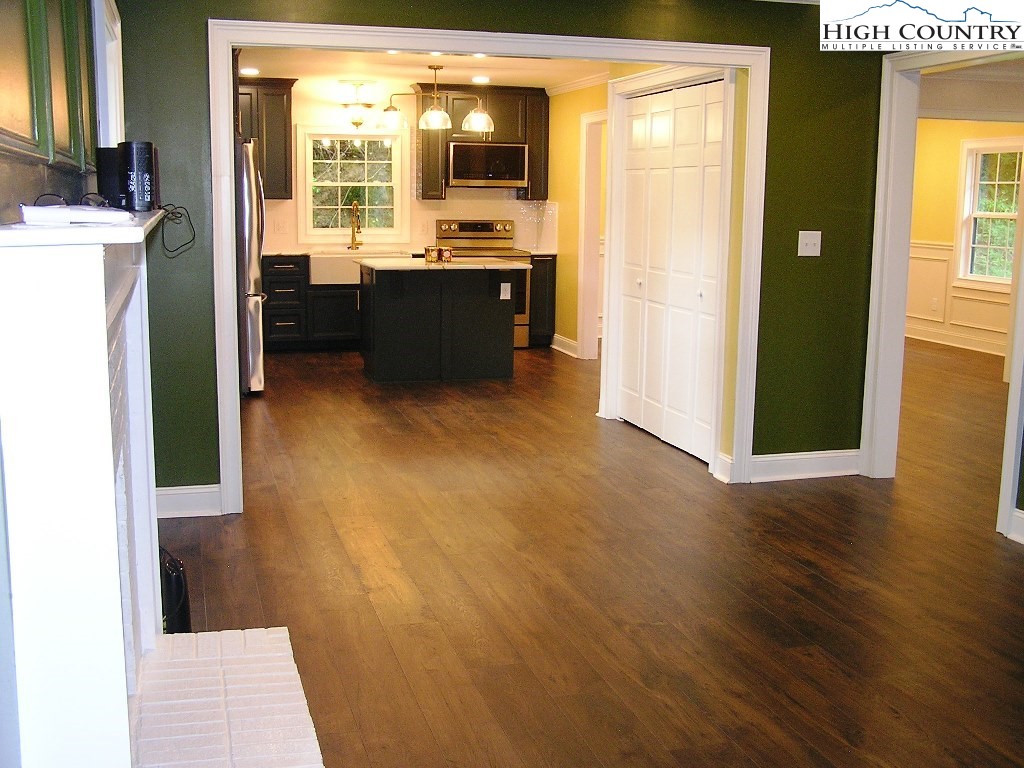 384 New River Heights Road Boone, NC 28607 - Photo 12 of 45 a view of a room with a sink and dishwasher with wooden floor