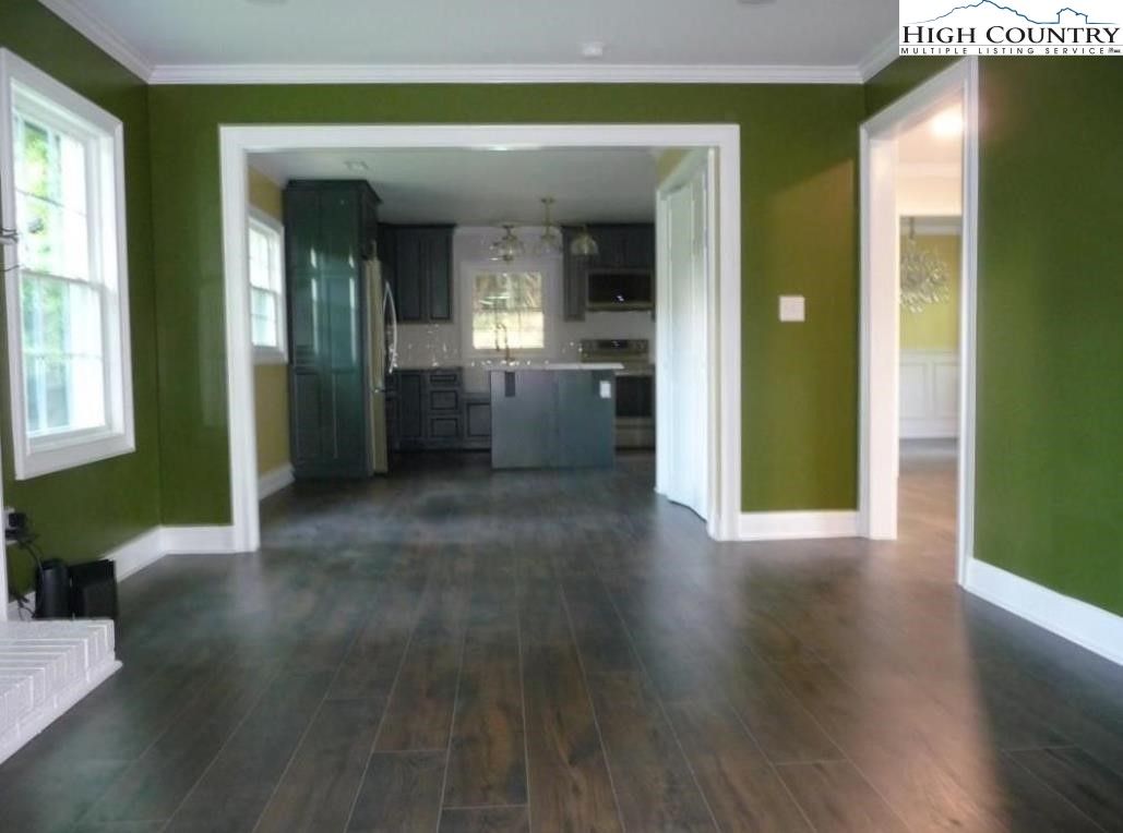 384 New River Heights Road Boone, NC 28607 - Photo 15 of 45 a view of a hallway with wooden floor and a living room