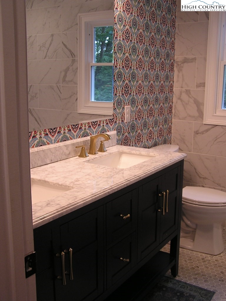 384 New River Heights Road Boone, NC 28607 - Photo 19 of 45 a bathroom with a sink and a toilet
