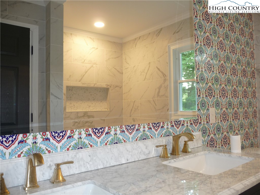 384 New River Heights Road Boone, NC 28607 - Photo 20 of 45 a bathroom with a granite countertop sink and a mirror