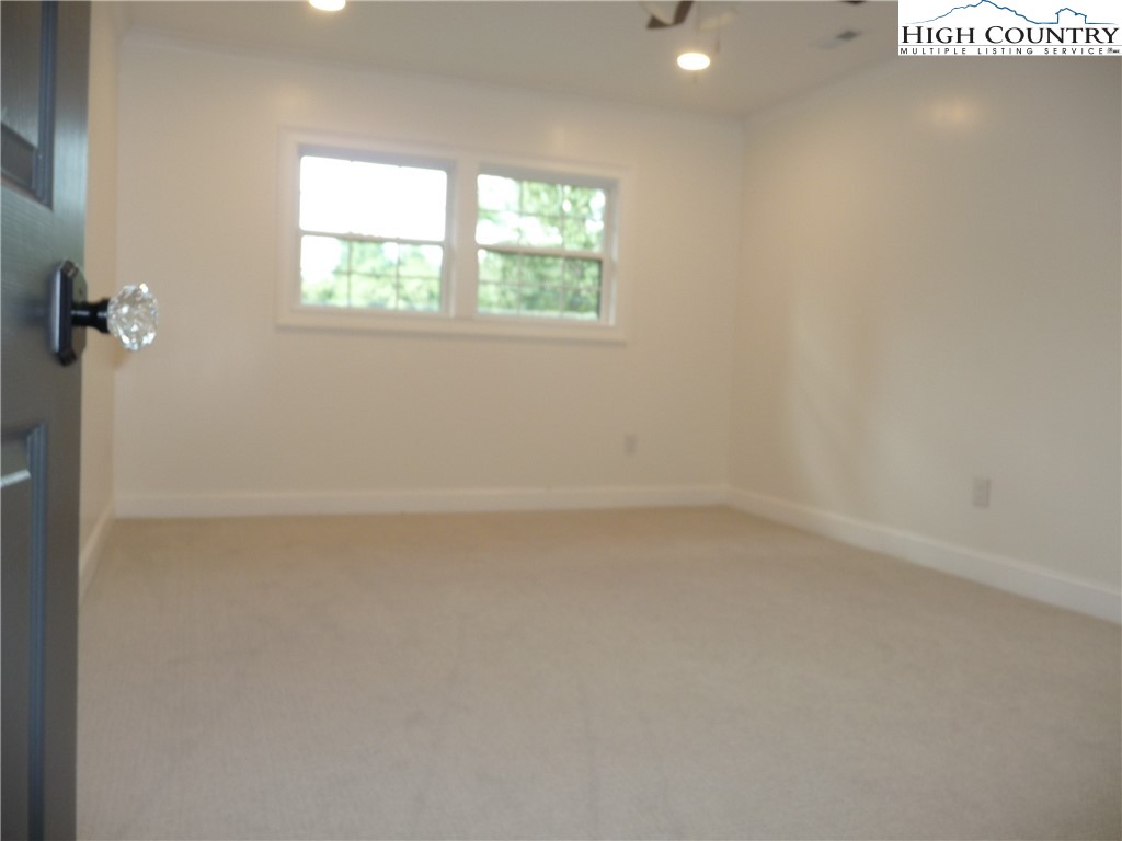 384 New River Heights Road Boone, NC 28607 - Photo 22 of 45 an empty room with a window