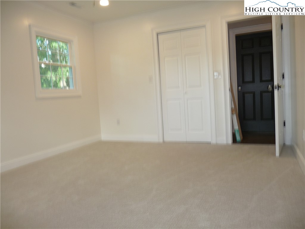 384 New River Heights Road Boone, NC 28607 - Photo 24 of 45 an empty room with windows and closet