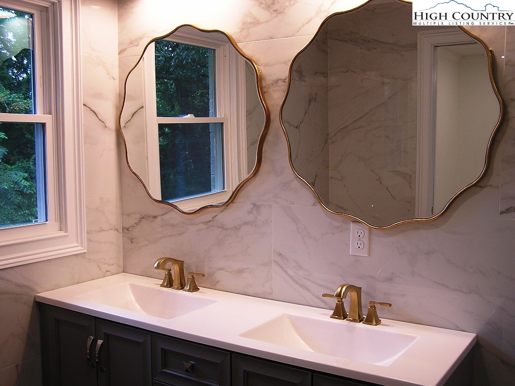384 New River Heights Road Boone, NC 28607 - Photo 27 of 45 a bathroom with a sink and mirror
