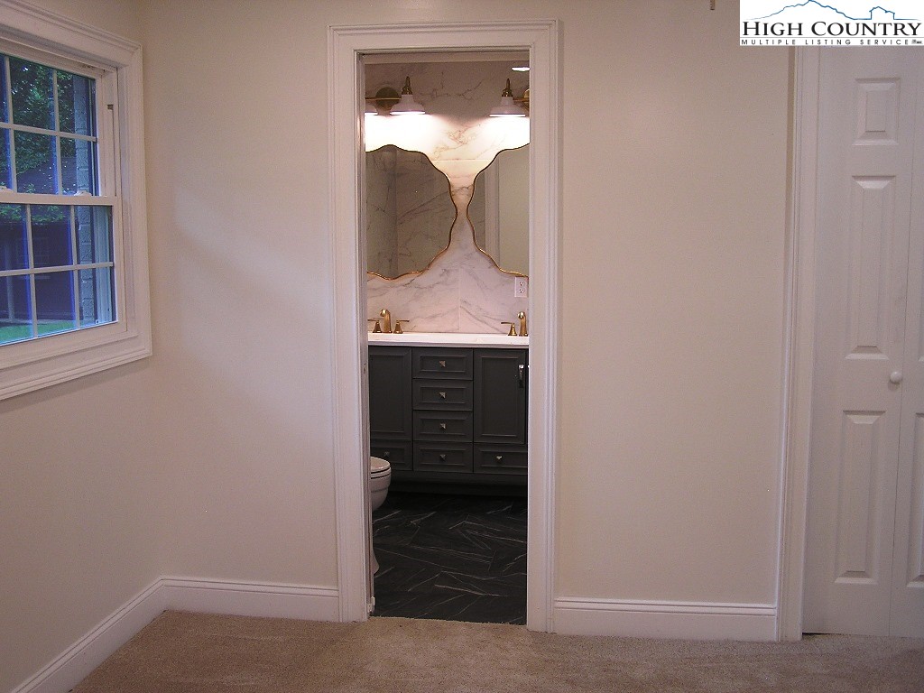 384 New River Heights Road Boone, NC 28607 - Photo 29 of 45 a bathroom with a sink and a mirror
