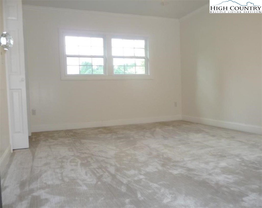 384 New River Heights Road Boone, NC 28607 - Photo 30 of 45 an empty room with a window