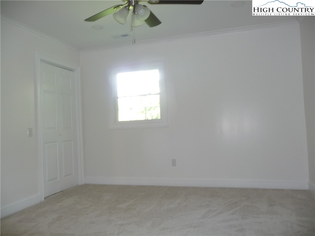 384 New River Heights Road Boone, NC 28607 - Photo 32 of 45 an empty room with a window