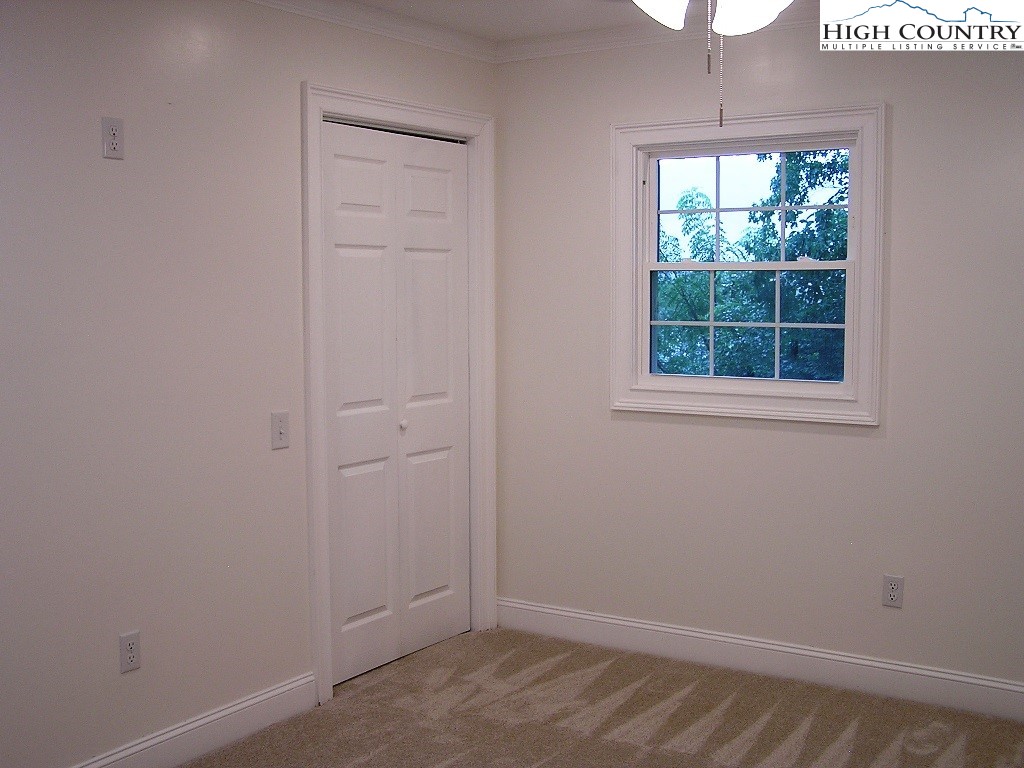 384 New River Heights Road Boone, NC 28607 - Photo 33 of 45 an empty room with a window