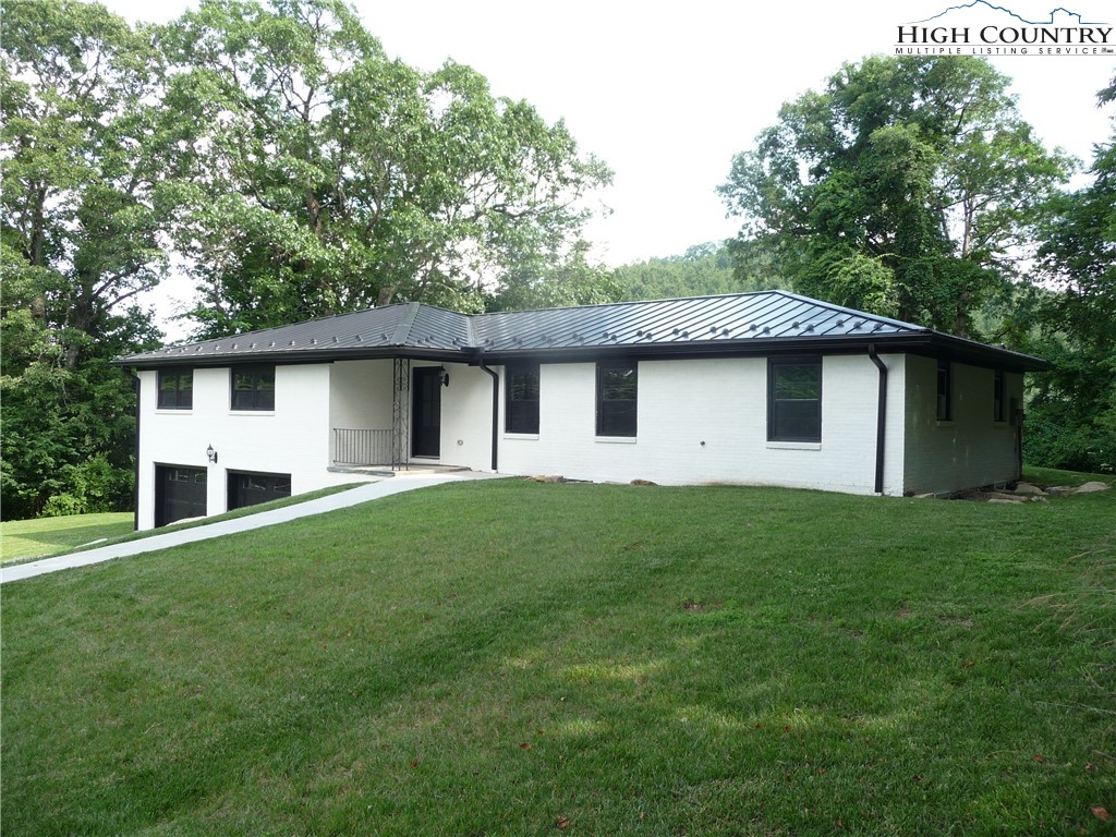 384 New River Heights Road Boone, NC 28607 - Photo 40 of 45 a house view with a garden space