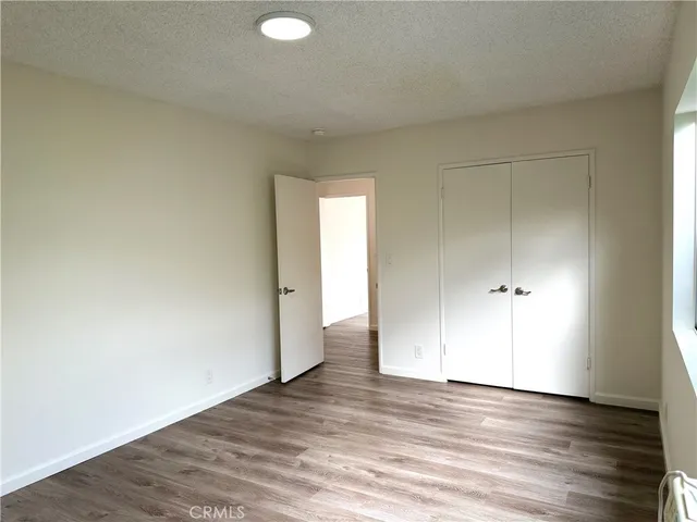 a view of an empty room and wooden floor