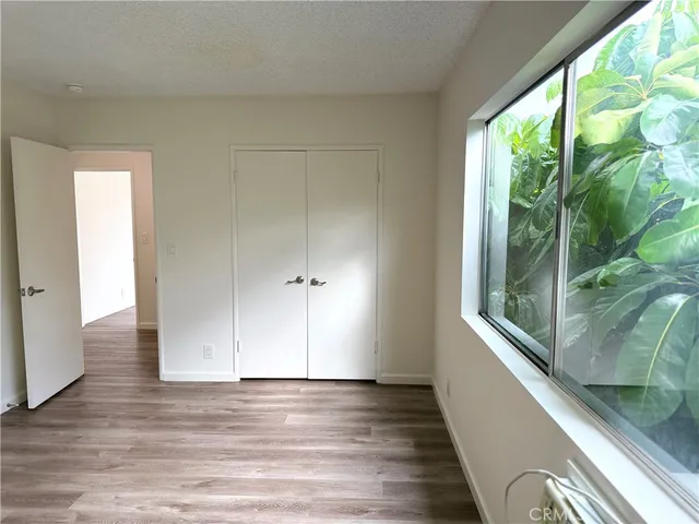 a view of a room with wooden floor and windows