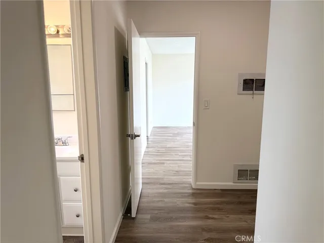 a view of a hallway with wooden floor