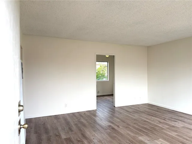 a view of an empty room and wooden floor
