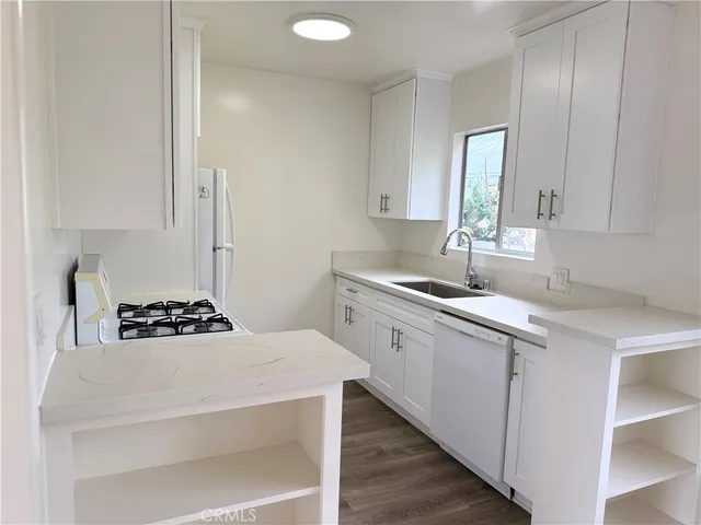 a kitchen with a sink stove and cabinets