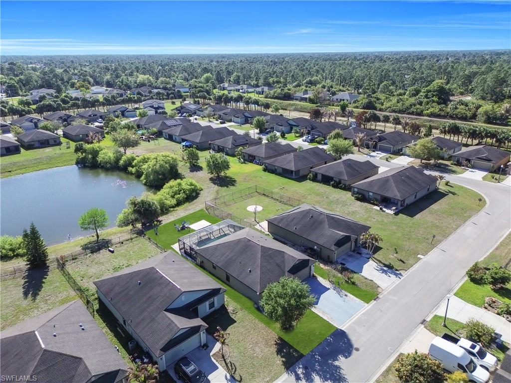 175 Shadowview Court Lehigh Acres, FL 33974 - Photo 36 of 39 an aerial view of a house with a swimming pool outdoor seating and yard