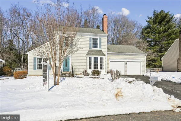 a view of a house with snow on the road