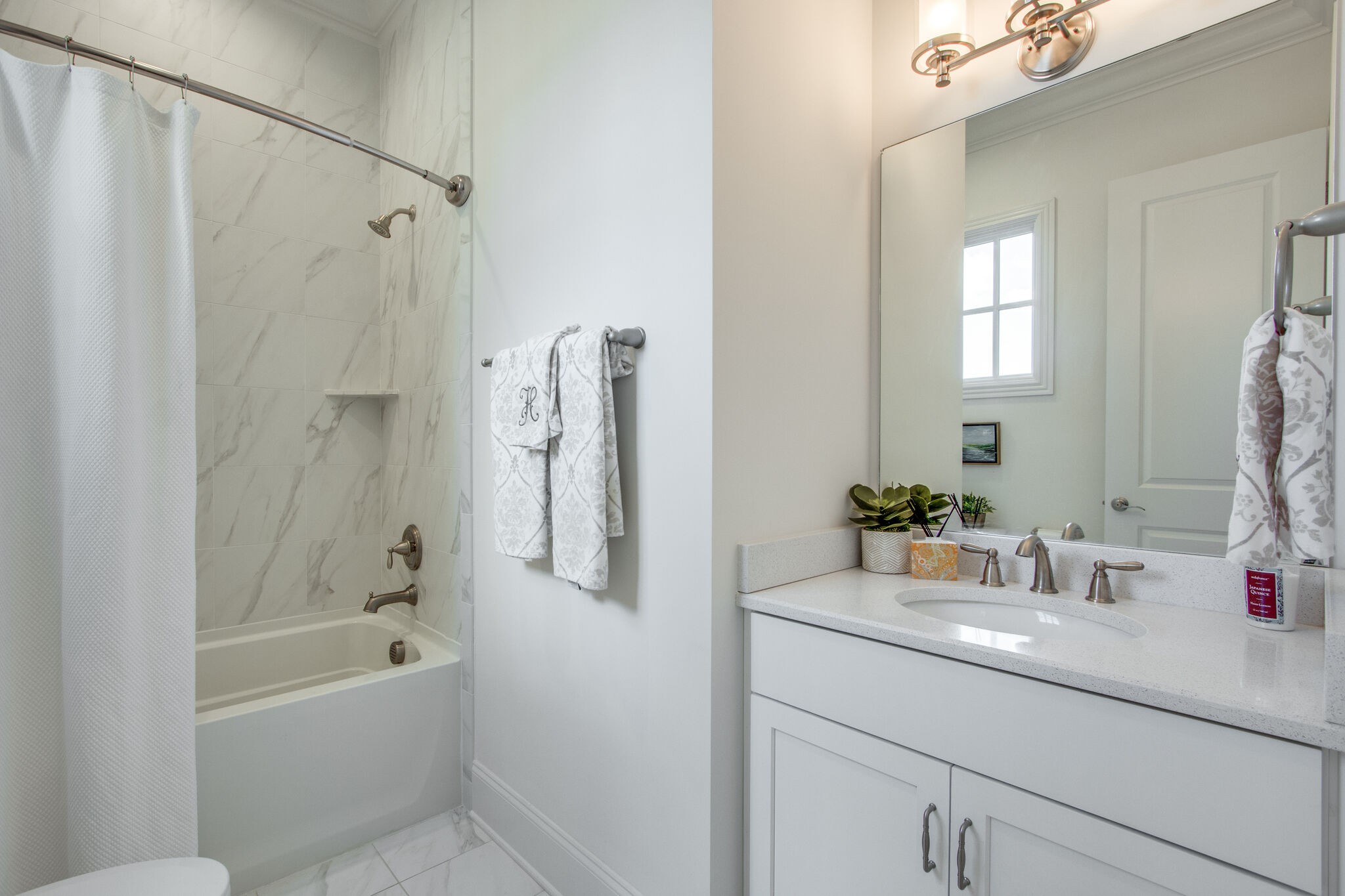 1606 Eliot Road Franklin, TN 37064 - Photo 37 of 67 a bathroom with a granite countertop sink a mirror a bathtub and shower