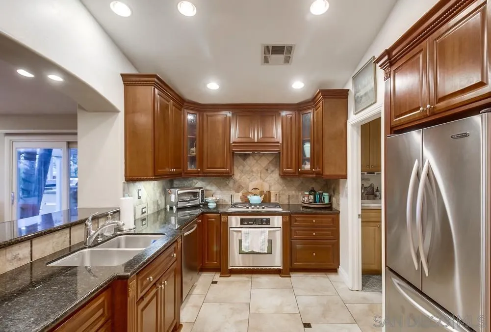 2548 Columbine Road Alpine, CA 91901 - Photo 24 of 71 a kitchen with stainless steel appliances granite countertop a sink stove and refrigerator