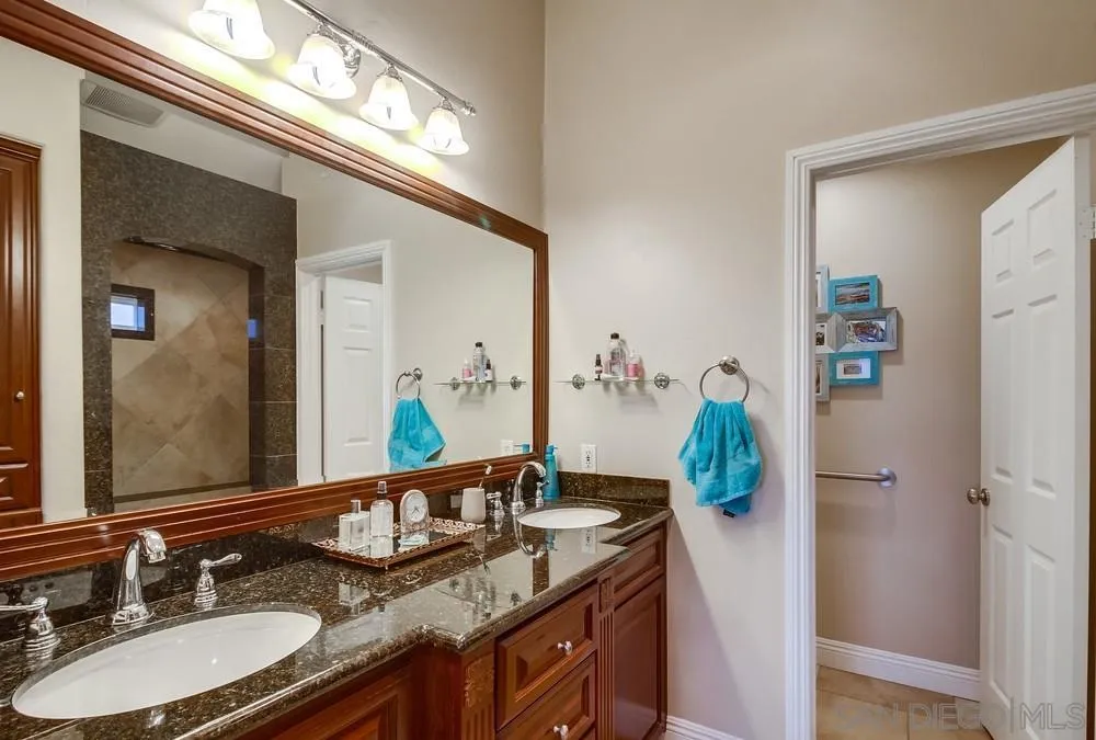 2548 Columbine Road Alpine, CA 91901 - Photo 28 of 71 a bathroom with a granite countertop sink and a mirror