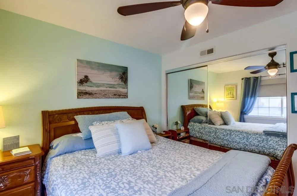 2548 Columbine Road Alpine, CA 91901 - Photo 34 of 71 a bedroom with a large bed and a chandelier