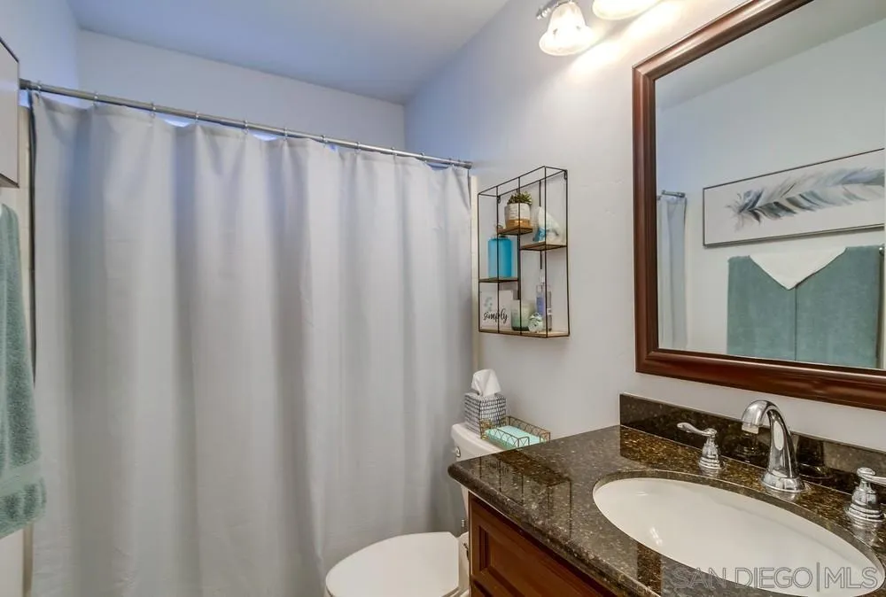 2548 Columbine Road Alpine, CA 91901 - Photo 36 of 71 a bathroom with a granite countertop sink and a mirror
