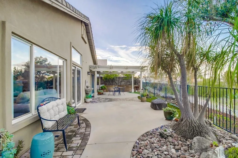 2548 Columbine Road Alpine, CA 91901 - Photo 43 of 71 a view of a patio with couches table and chairs potted plants and palm tree