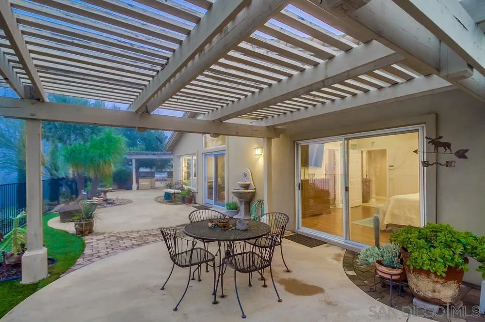 2548 Columbine Road Alpine, CA 91901 - Photo 46 of 71 a view of a patio with table and chairs and potted plants