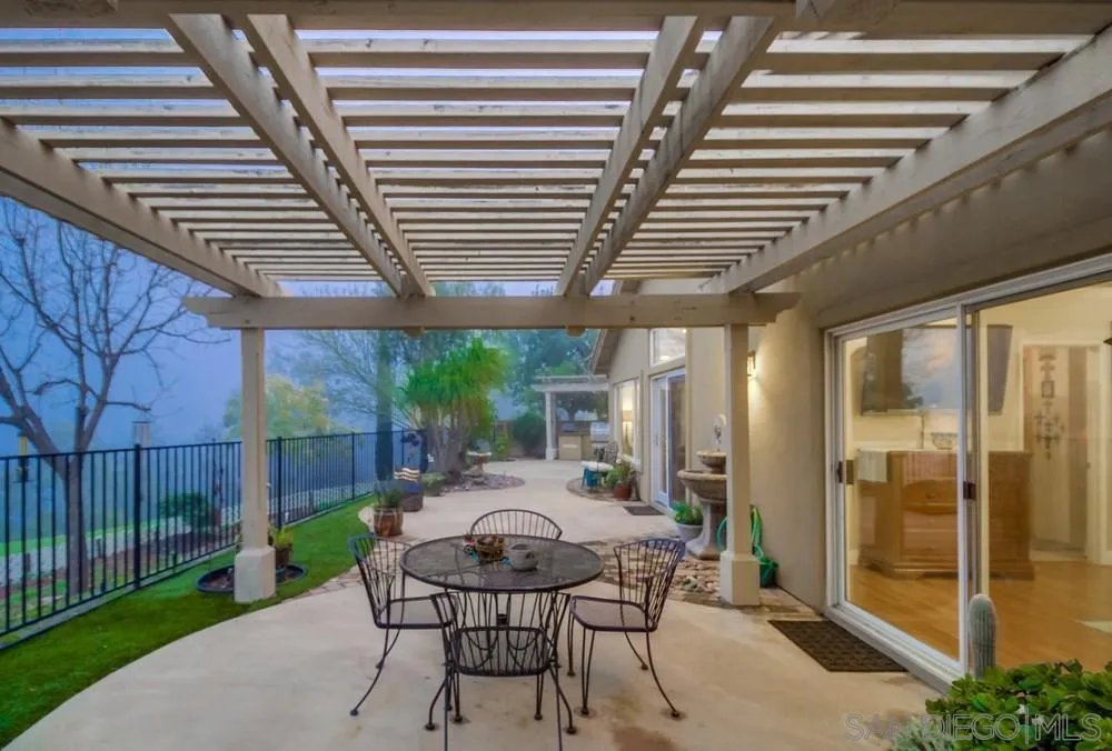 2548 Columbine Road Alpine, CA 91901 - Photo 47 of 71 a view of a patio with table and chairs with wooden floor and fence