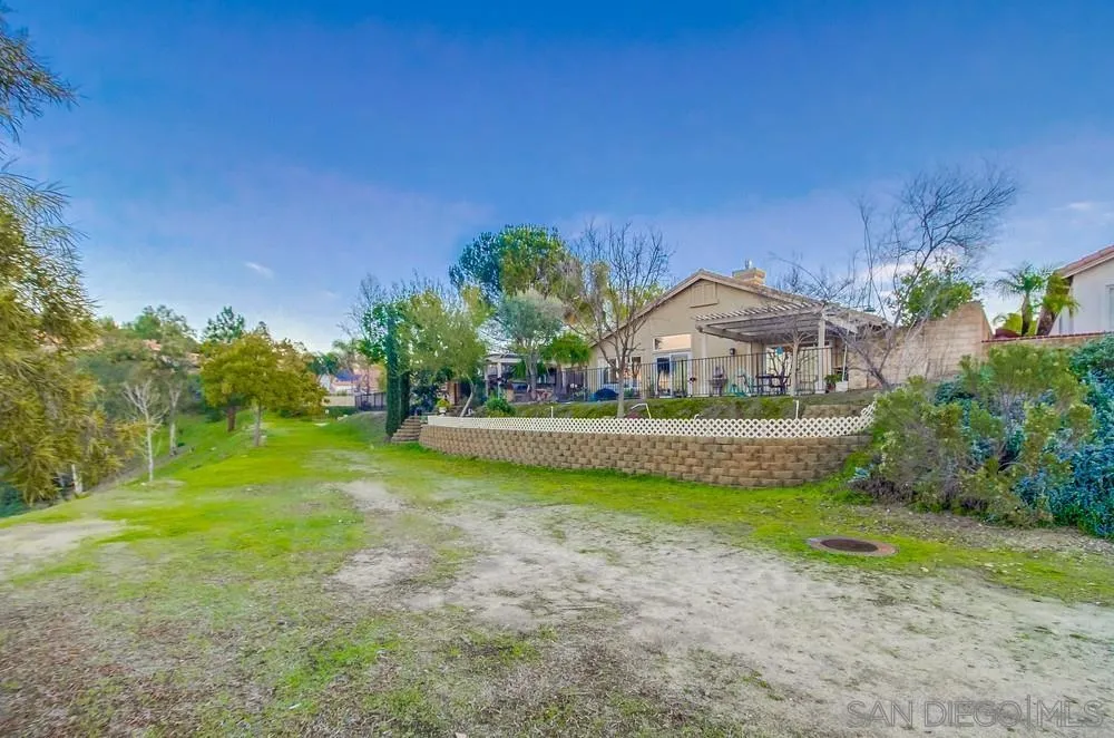 2548 Columbine Road Alpine, CA 91901 - Photo 60 of 71 a view of a house with a yard and a garden