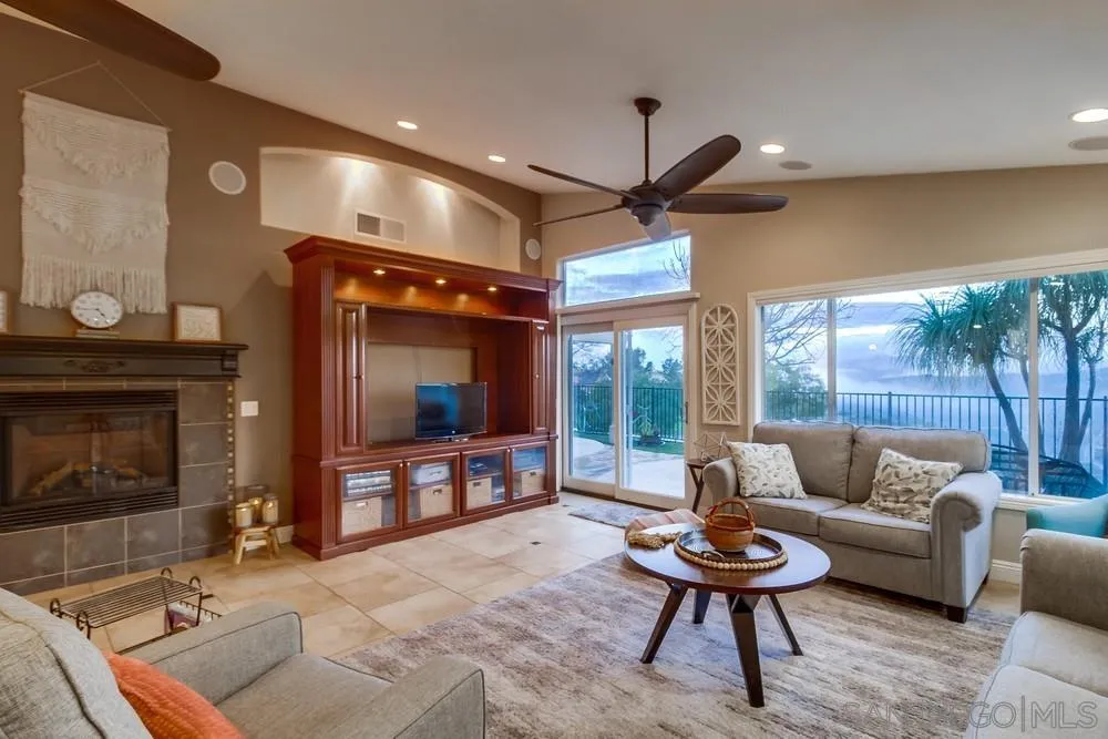 2548 Columbine Road Alpine, CA 91901 - Photo 8 of 71 a living room with furniture a ceiling fan and a fireplace
