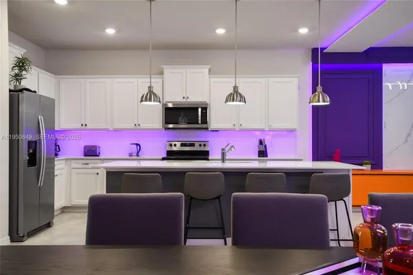 a spacious bedroom with a bed and a flat screen tv