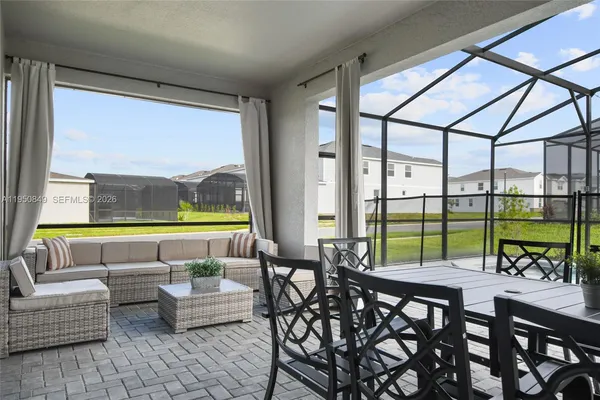 a view of a patio with a dining table and chairs with wooden floor