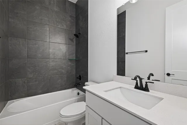 a bathroom with a sink a toilet and a bathtub