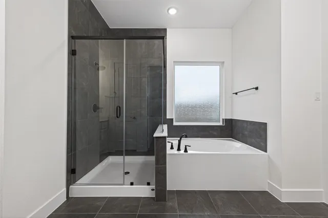 a bathroom with a tub and a shower