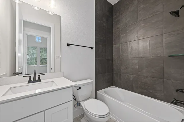 a bathroom with a sink toilet a mirror and shower