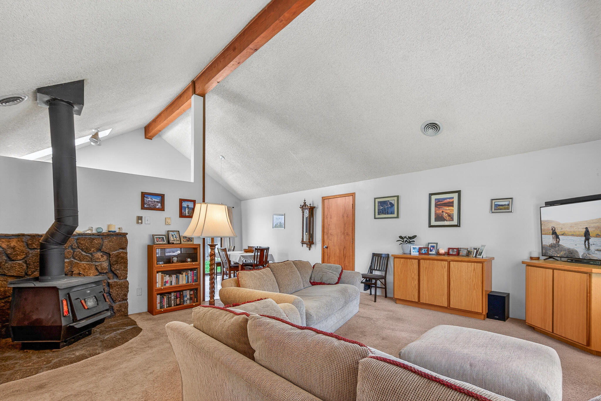 60866 Brosterhous Road Bend, OR 97702 - Photo 7 of 41 a living room with furniture and a flat screen tv