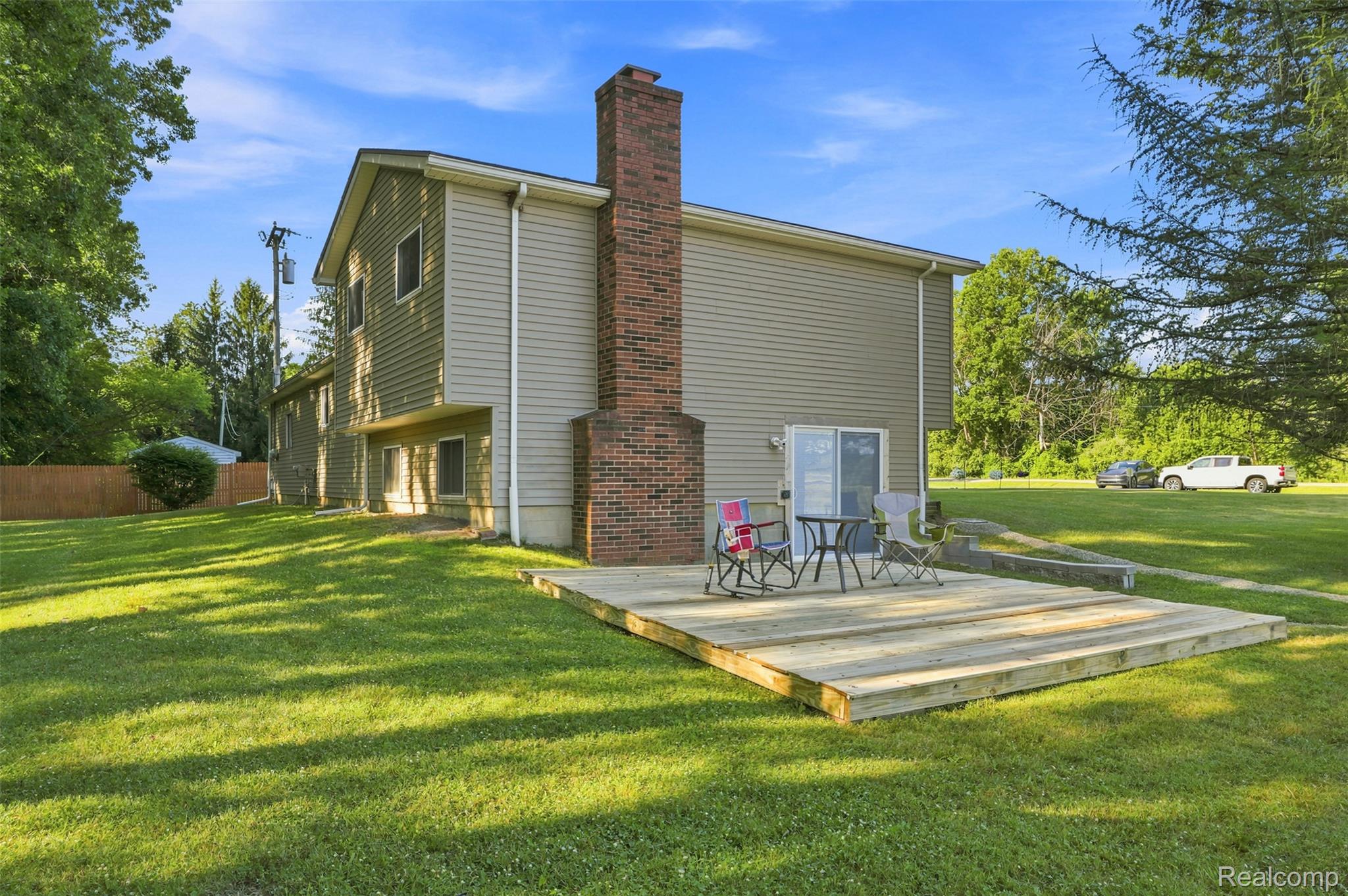 3744 Fish Lake Road Lapeer, MI 48446 - Photo 27 of 50 Expansive green lawn featuring a ground-level wood deck