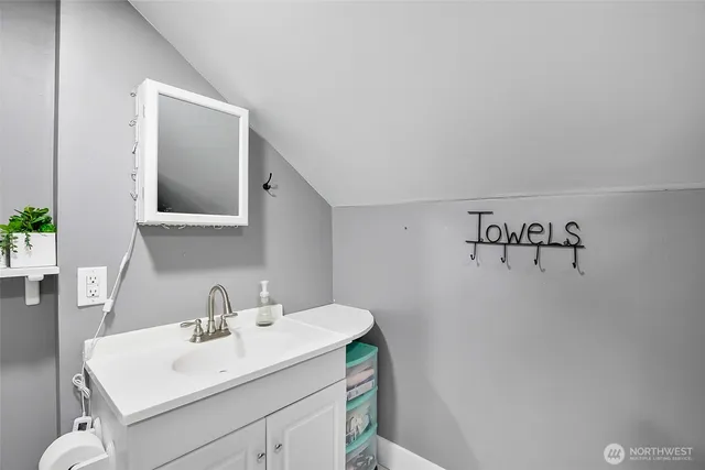 a bathroom with a sink vanity and mirror