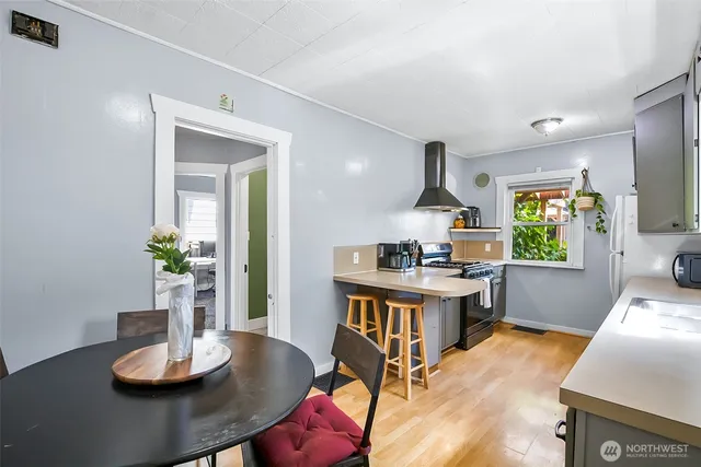 a living room with kitchen island furniture and a wooden floor