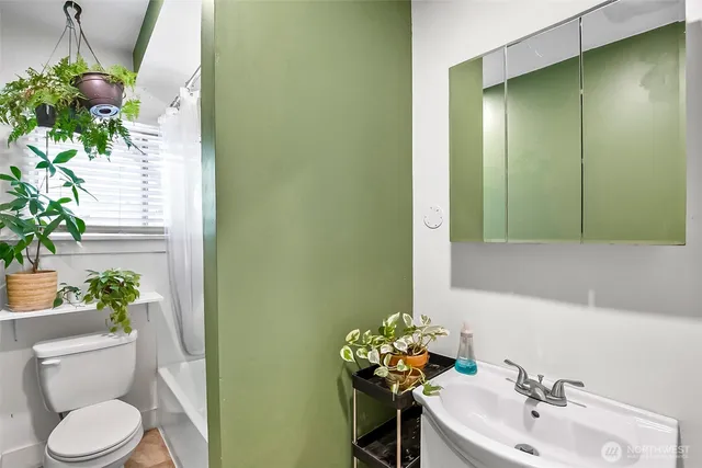 a bathroom with a sink a toilet and a mirror