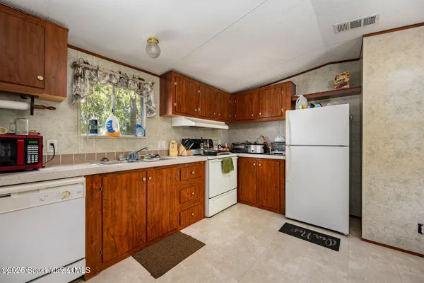 a view of a car garage bed and a refrigerator