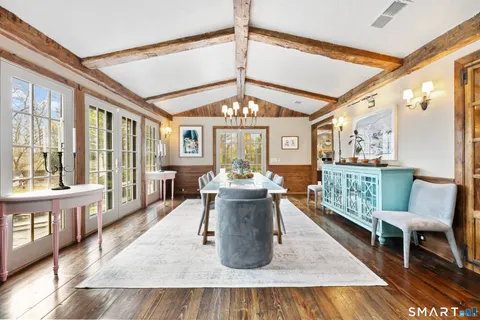 a living room with furniture wooden floor and kitchen view