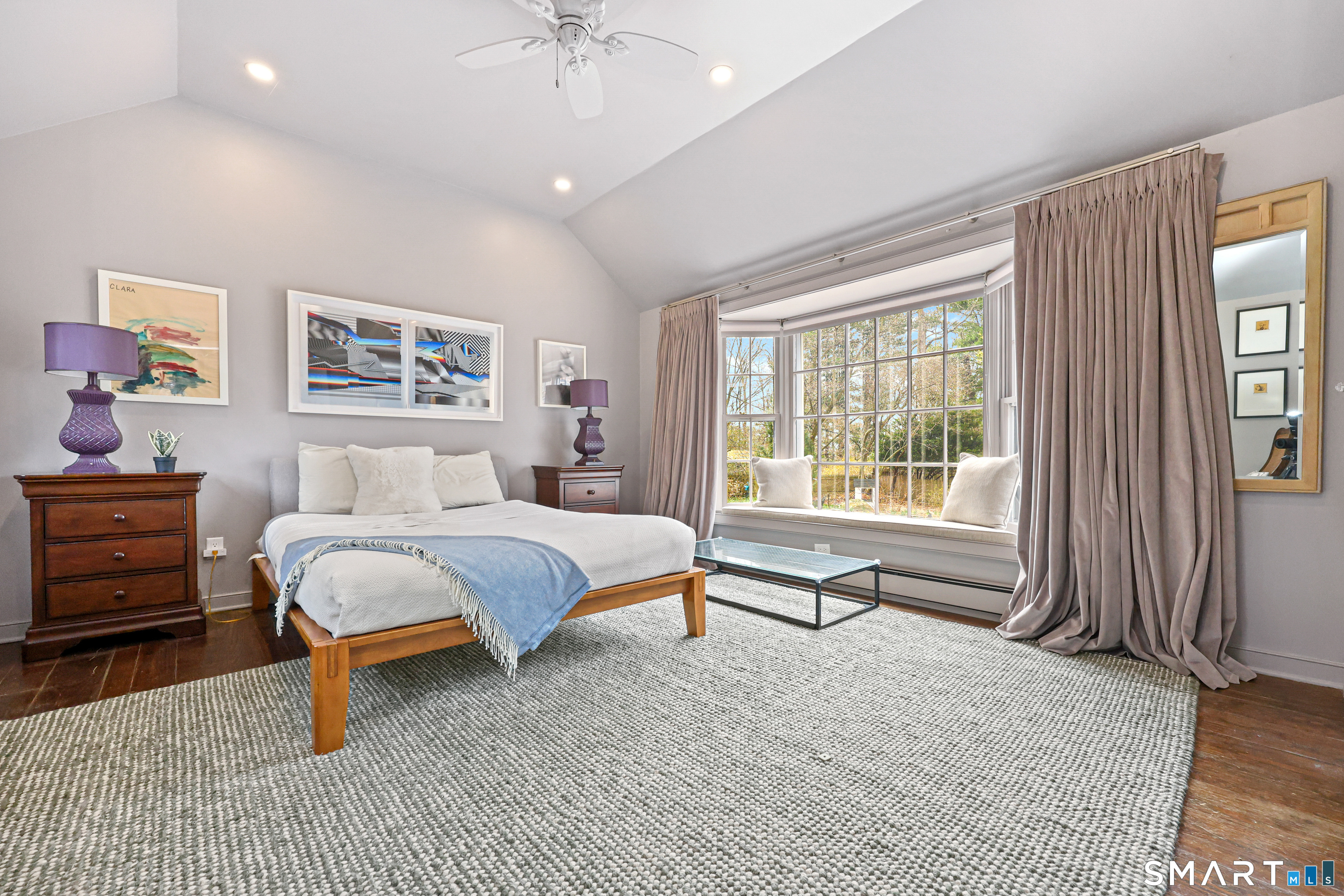 151 Skunk Lane Wilton, CT 06897 - Photo 15 of 39 a bedroom with a bed and a chandelier