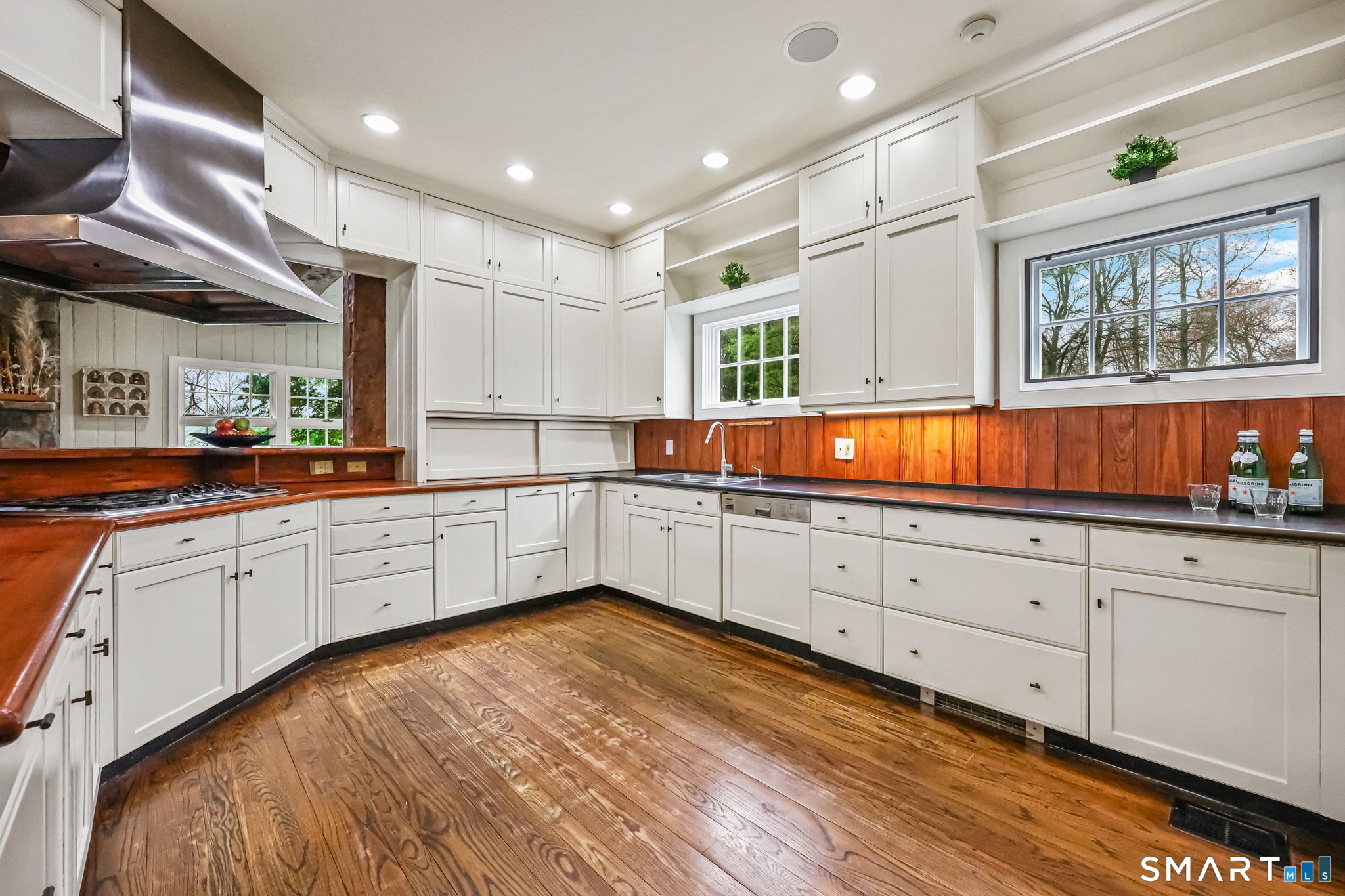 151 Skunk Lane Wilton, CT 06897 - Photo 18 of 39 a kitchen with granite countertop white cabinets and wooden floors