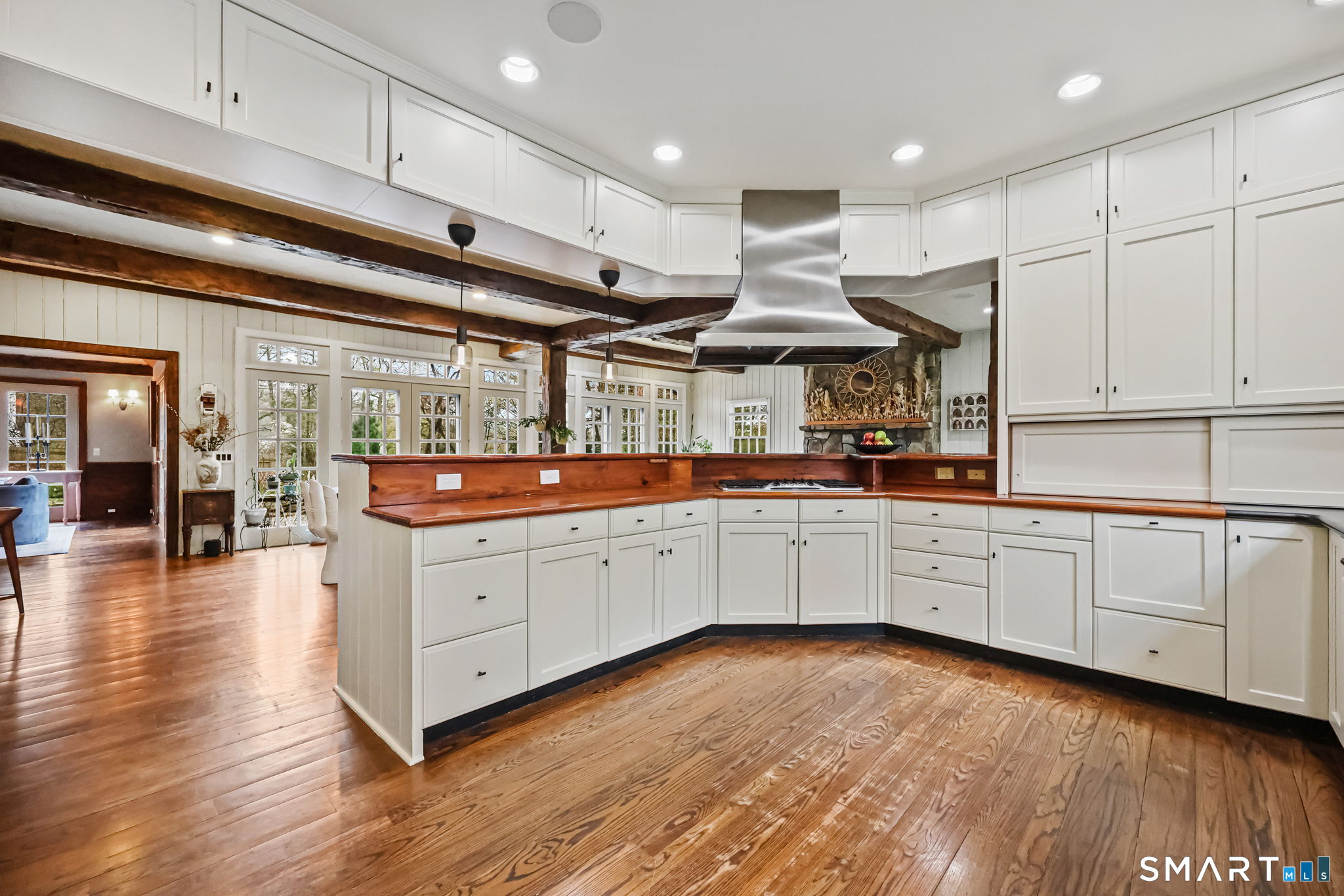 151 Skunk Lane Wilton, CT 06897 - Photo 20 of 39 a kitchen with white cabinets with wooden floors and white stainless steel appliances