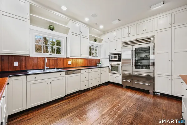 a living room with furniture a rug and a large window