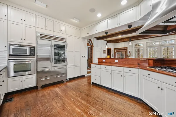 a kitchen with cabinets and steel stainless steel appliances