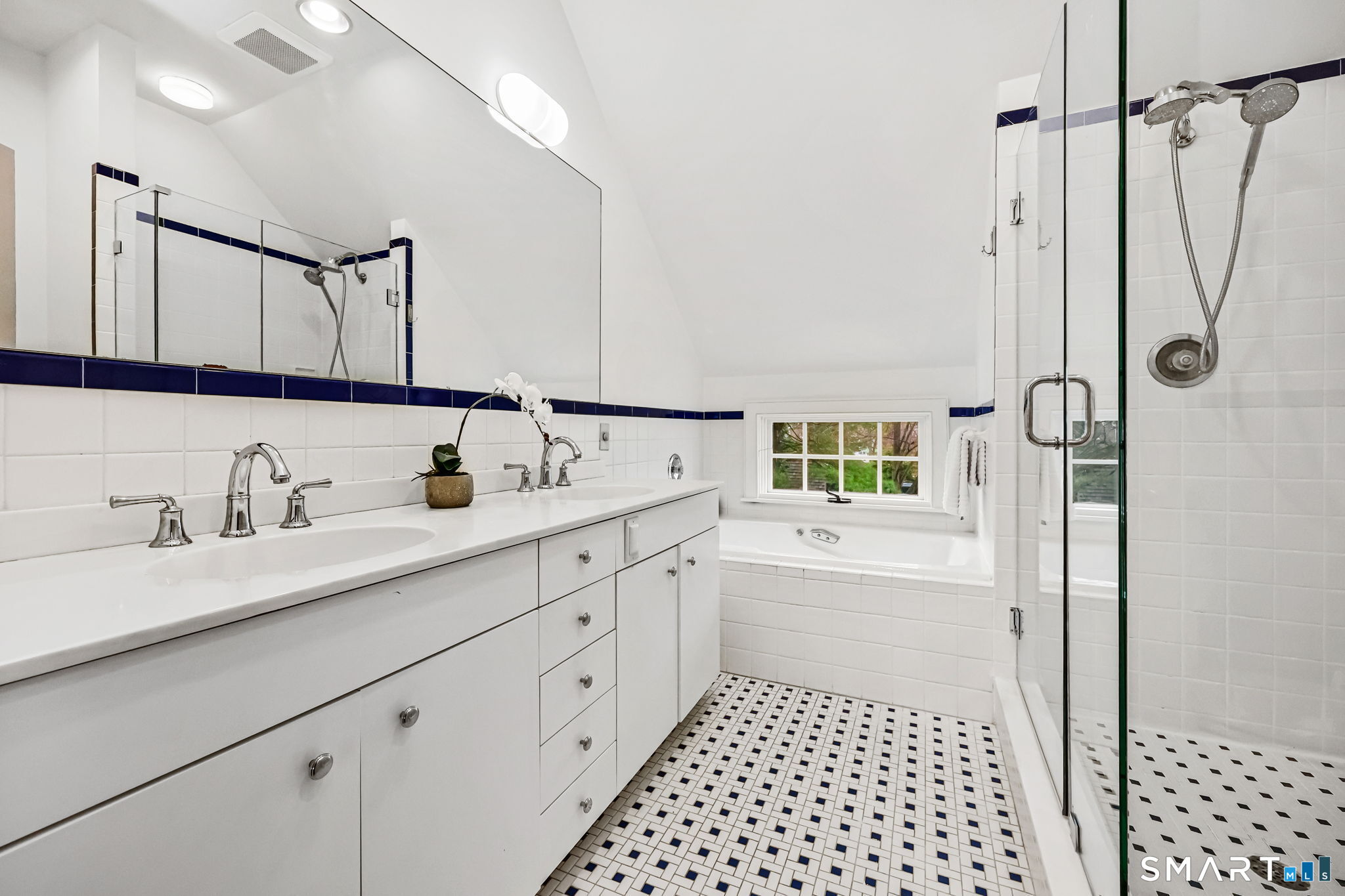 151 Skunk Lane Wilton, CT 06897 - Photo 31 of 39 a bathroom with a double vanity sink a mirror a vanity and a shower