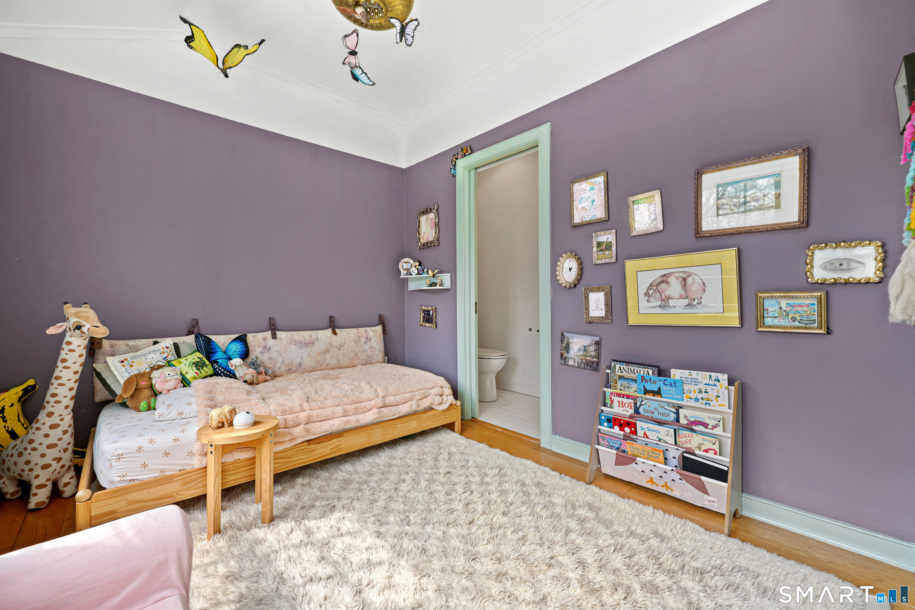 151 Skunk Lane Wilton, CT 06897 - Photo 35 of 39 a bedroom with bed and wooden floor
